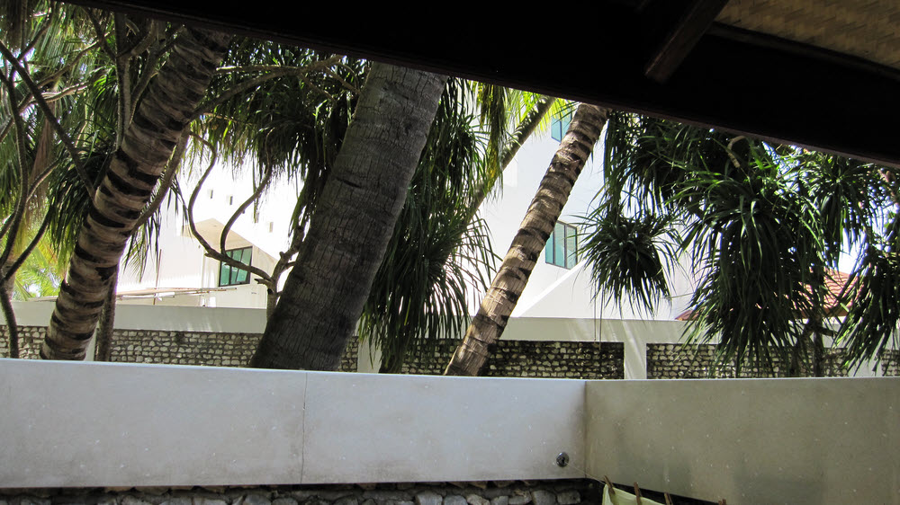 The view from the open-air bathroom of beach bungalow number 5.�Not encouraging to see that these windows in the staff quarters overlook me on the loo.... (175k)